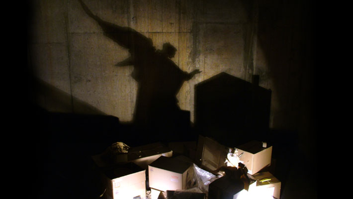 The shadow of St Gabriel, the patron saint of postmen, made from a pile of undelivered mail